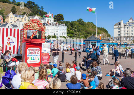 punch and judy llandudno north wales kids watching a traditional punch and judy show with puppets on the promenade llandudno gwynedd north wales Stock Photo