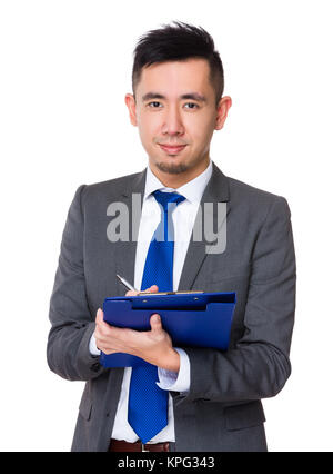 Asian young businessman take note on clipboard Stock Photo - Alamy
