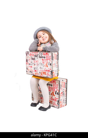 girl sitting on suitcase Stock Photo