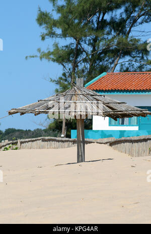 Mozambique, house with rustic wooden umbrella at the beach in Ponta Do Ouro Stock Photo