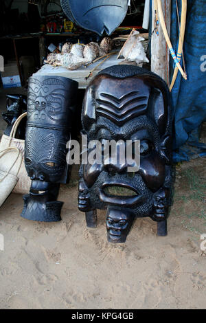 Mozambique, traditional wooden african masks and curios for sale on a beach in Ponta Do Ouro Stock Photo