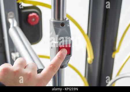 man pressing button on bus Stock Photo