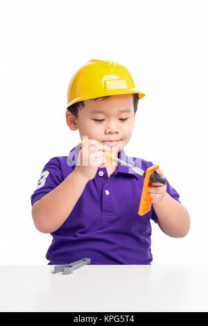 Little repairman in hardhat with repair tools Stock Photo