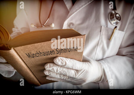 Doctor holds in a Munchausen syndrome book in a hospital. Conceptual image Stock Photo