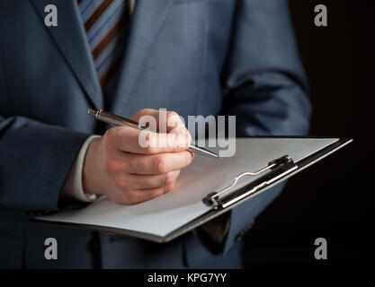 Businessman signing a contract Stock Photo