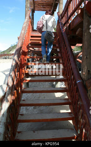 Lady climbing boardwalk stairs at Gonubie beach, East London Stock Photo