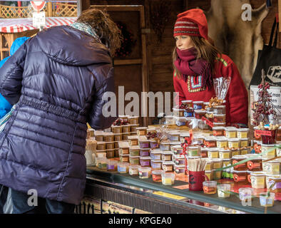 Brunswick, Lower Saxony, Germany, December 7th 2017: Booth with honey from Finland with a shop assistant in Finnish costume at the Christmas market in Stock Photo