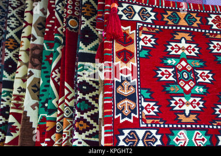 pile of turkish kilims as a colorful background handmade woven rugs and tapestry vintage carpets Stock Photo