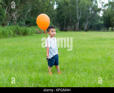 Young boy holding balloon Stock Photo