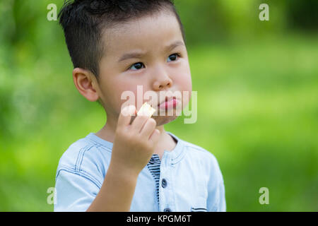 Little kid eating snack Stock Photo