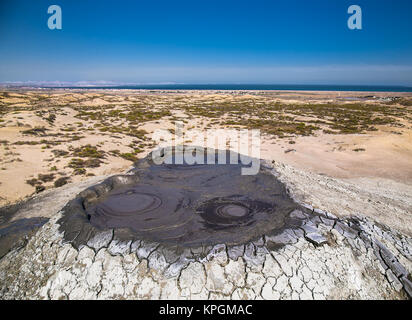 Top of mud crater volcano in Gobustan with eruption bubbling mud. Azerbaijan. Stock Photo