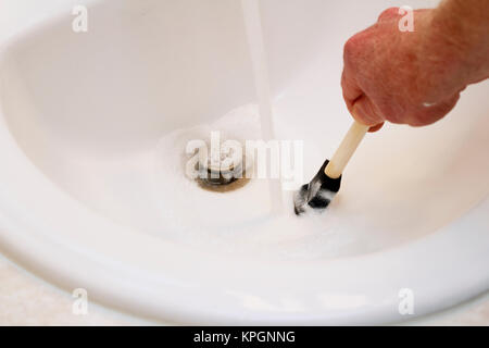 Hand of a Man Cleaning Paint from a Paintbrush Stock Photo