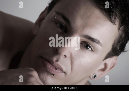 Model released , Junger Mann, 27, mit Gesichtspiercings - man with face piercings Stock Photo