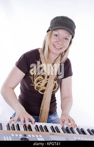 Model released , Junge Frau, 25+, spielt am Keyboard - woman plays on keyboard Stock Photo