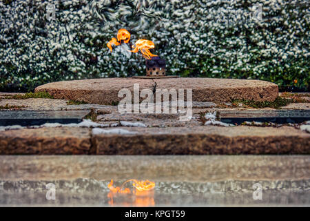 Winter and the Eternal Flame at John F. Kennedy's grave in Arlington National Cemetery. Stock Photo