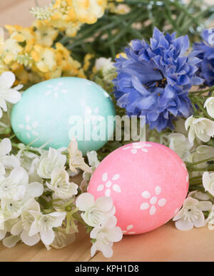 Two decorated Easter eggs among colorful flowers Stock Photo