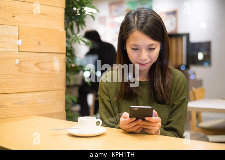 Woman sending message on mobile phone Stock Photo