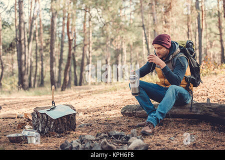 man drinking tea in forest Stock Photo