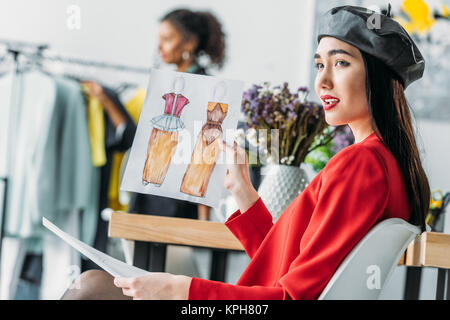 asian fashion designer with sketches Stock Photo