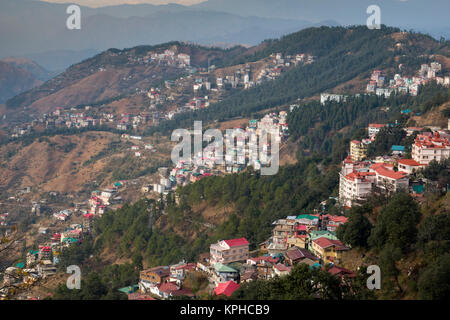 Apartment buildings and houses on side of mountain in Shimla, India Stock Photo