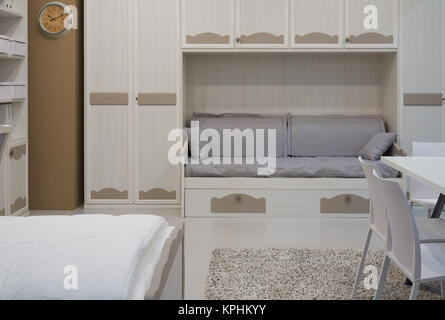 New comfortable furniture: double bed, table, chairs, sofa, wardrobe in the room Stock Photo