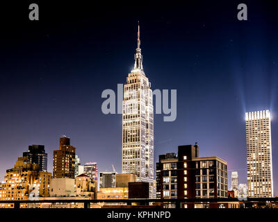 NEW YORK, USA - JANUARY 5, 2015: The Empire State Building seen through the Manhattan Bridge in the afternoon. The Empire State Building is a 102-stor Stock Photo