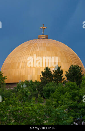 USA, WA, Denver. Assumption of the Theotokos Greek Orthodox Cathedral known for its dramatic gold dome contrasts with storm sky. Stock Photo