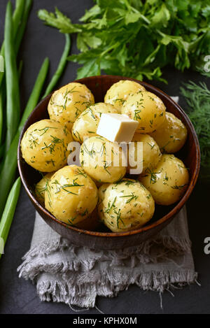 Tasty boiled potatoes with dill and butter in bowl. Dish for dinner Stock Photo