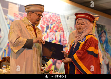 QUETTA, PAKISTAN. Dec-14 2017: Chancellor and Governor of Balochistan Mr. Muhammad Khan Achakzai awarding degree to pass out graduates during ceremony Stock Photo