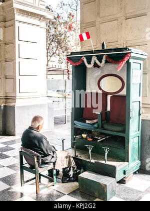 Lima, Peru - October 11, 2014 - A shoe cleaner in Lima (Peru) waiting the clients to come. Stock Photo