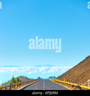 Road to the clouds - Perspective highland road in Teide National Park, Tenerife. Copyspace composition Stock Photo