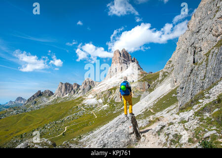 Hiker on the circular hiking trail from Passo Giau via Nuvolau, view of the Averau peaks, Dolomites, South Tyrol Stock Photo