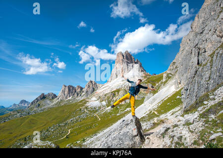 Hiker on the circular hiking trail from Passo Giau via Nuvolau, view of the Averau peaks, Dolomites, South Tyrol Stock Photo