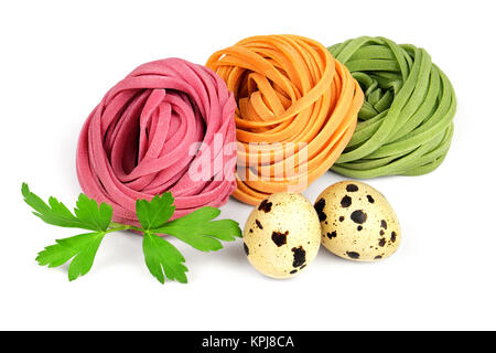 Colored fettuccine pasta, quail eggs and parsley. Stock Photo