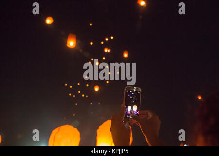 Colombo, Sri Lanka. 16th December, 2017. local resident take a photo during the event of light the sky - Sky lantern festival colombo, Sri Lanka. Credit: Vimukthi Embuldeniya/Alamy Live News Stock Photo