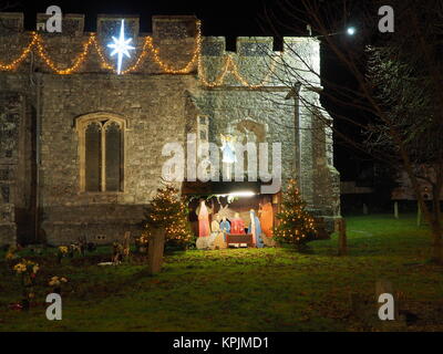 Eastchurch, Kent, UK. 16th Dec, 2017. The Christmas lights on display in the small village of Eastchurch (population 3000) on the Isle of Sheppey in Kent. All Saints Church brightly lit up and exhibiting a traditional nativity scene. Eastchurch is styled the 'home of British aviation' as Eastchurch airfield saw the first controlled flight by a British pilot on British soil. Credit: James Bell/Alamy Live News Stock Photo