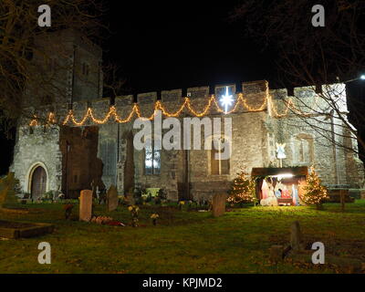 Eastchurch, Kent, UK. 16th Dec, 2017. The Christmas lights on display in the small village of Eastchurch (population 3000) on the Isle of Sheppey in Kent. All Saints Church brightly lit up and exhibiting a traditional nativity scene. Eastchurch is styled the 'home of British aviation' as Eastchurch airfield saw the first controlled flight by a British pilot on British soil. Credit: James Bell/Alamy Live News Stock Photo