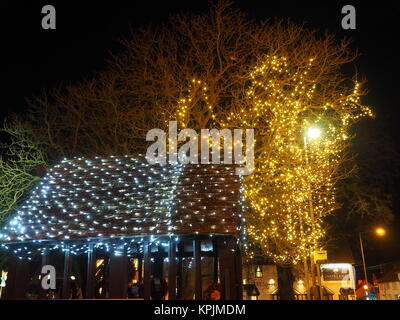 Eastchurch, Kent, UK. 16th Dec, 2017. The Christmas lights on display in the small village of Eastchurch (population 3000) on the Isle of Sheppey in Kent. All Saints Church brightly lit up and exhibiting a traditional nativity scene. Eastchurch is styled the 'home of British aviation' as Eastchurch airfield saw the first controlled flight by a British pilot on British soil. Credit: James Bell/Alamy Live News Stock Photo