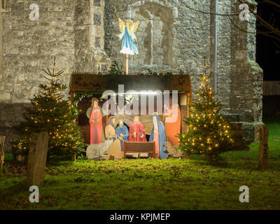 Eastchurch, Kent, UK. 16th Dec, 2017. The Christmas lights on display in the small village of Eastchurch (population 3000) on the Isle of Sheppey in Kent. All Saints Church brightly lit up and exhibiting a traditional nativity scene. Eastchurch is styled the 'home of British aviation' as Eastchurch airfield saw the first controlled flight by a British pilot on British soil. Credit: James Bell/Alamy Live News Stock Photo