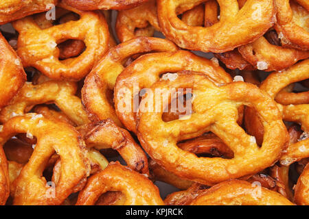 Mini pretzel. Pretzel shaped bread sticks cracker texture pattern. Salted pretzels. Food photo. Stock Photo