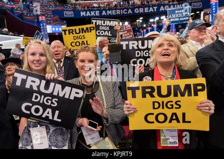 Coal supporters hold up signs that say Trump Digs Coal during an address on coal during the second day of the Republican National Convention via live video link July 19, 2016 in Cleveland, Ohio. Earlier in the day the delegates formally nominated Donald J. Trump for president. Stock Photo