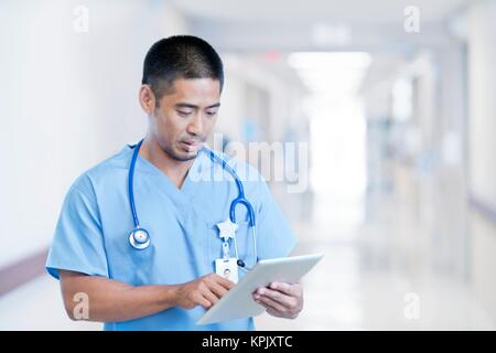 Male doctor using digital tablet. Stock Photo