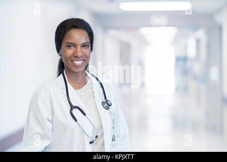Female doctor in white coat with stethoscope. Stock Photo