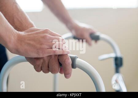 Patient using walking frame, close up. Stock Photo