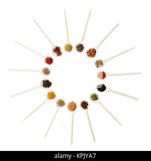 Dried spices on white spoons, studio shot. Stock Photo