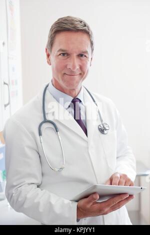 Male doctor using digital tablet. Stock Photo
