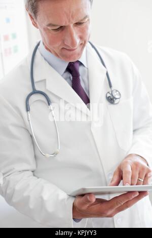 Male doctor using digital tablet. Stock Photo
