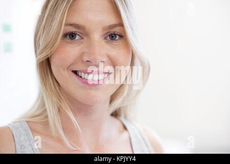 Portrait of young woman with blond hair in doctor's studio. Stock Photo