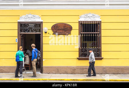 LIMA, PERU - SEPTEMBER 17, 2015. Two generations face to face in the streets of Lima. Stock Photo