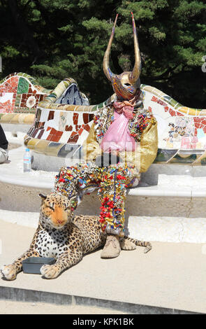 Colourful horned street performer on the roof of the Hypostyle Hall, Park Guell, Barcelona, Spain. Stock Photo